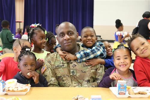Soldier with smiling children 